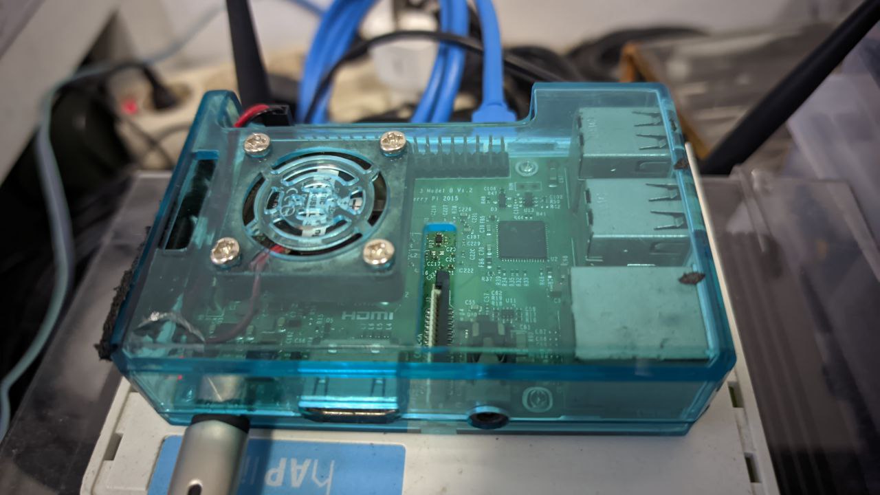 Raspberry Pi 3B with Blue Case and Connected to Power Cable